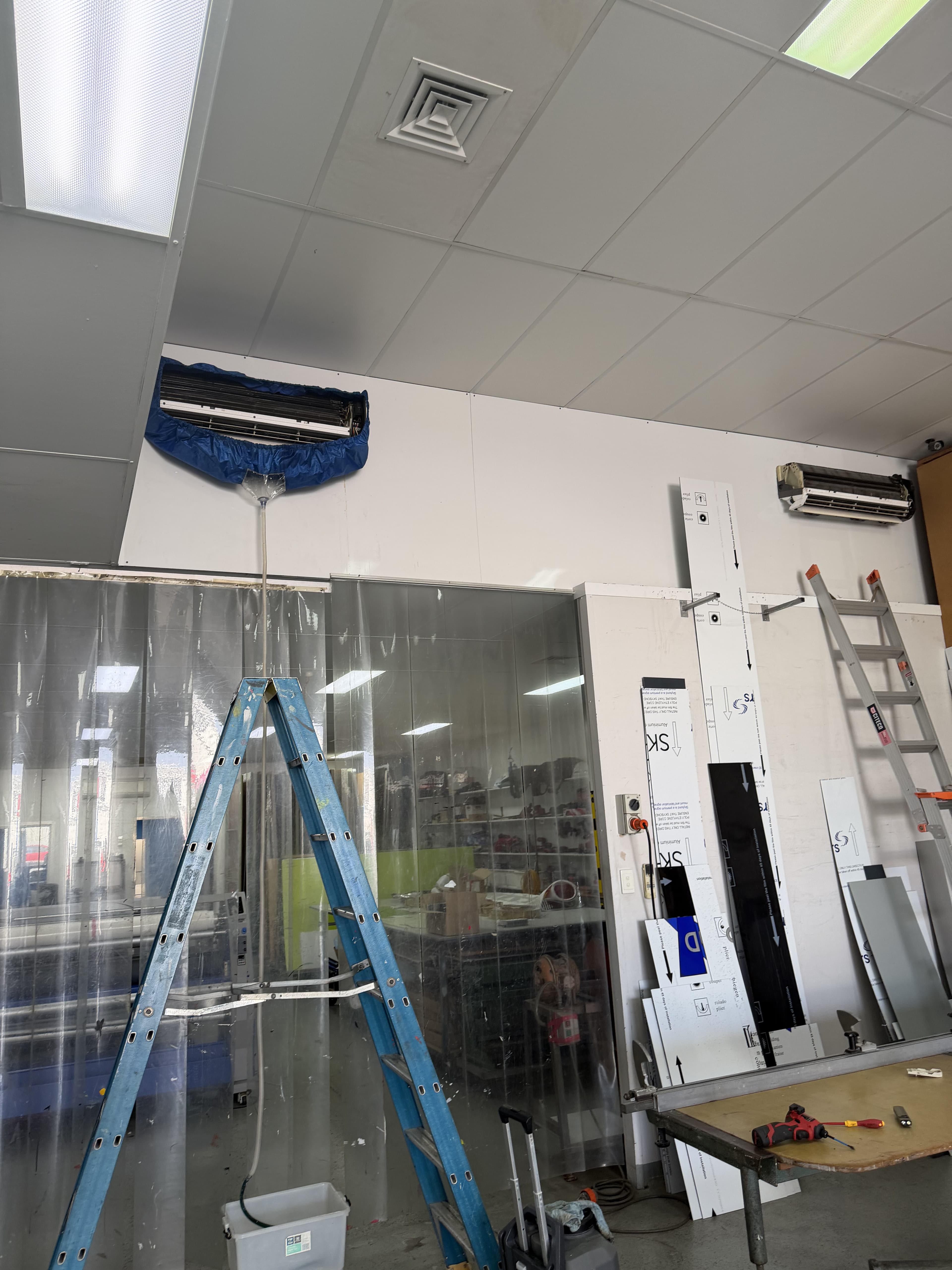 Indoor split system fitted with a protective catch-bag ready for a deep clean wash-down