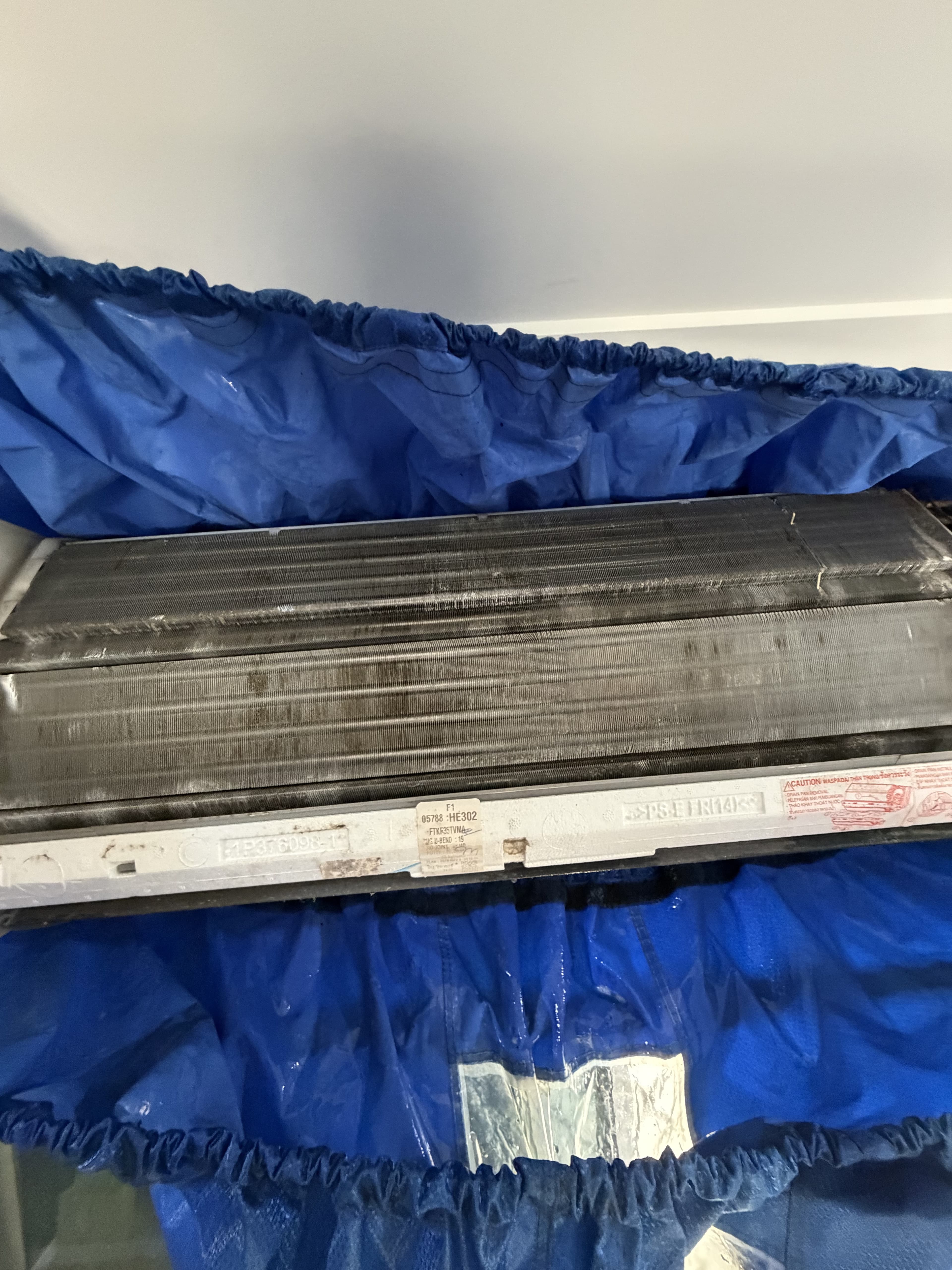 Close-up of a dirty indoor coil before a split system deep clean