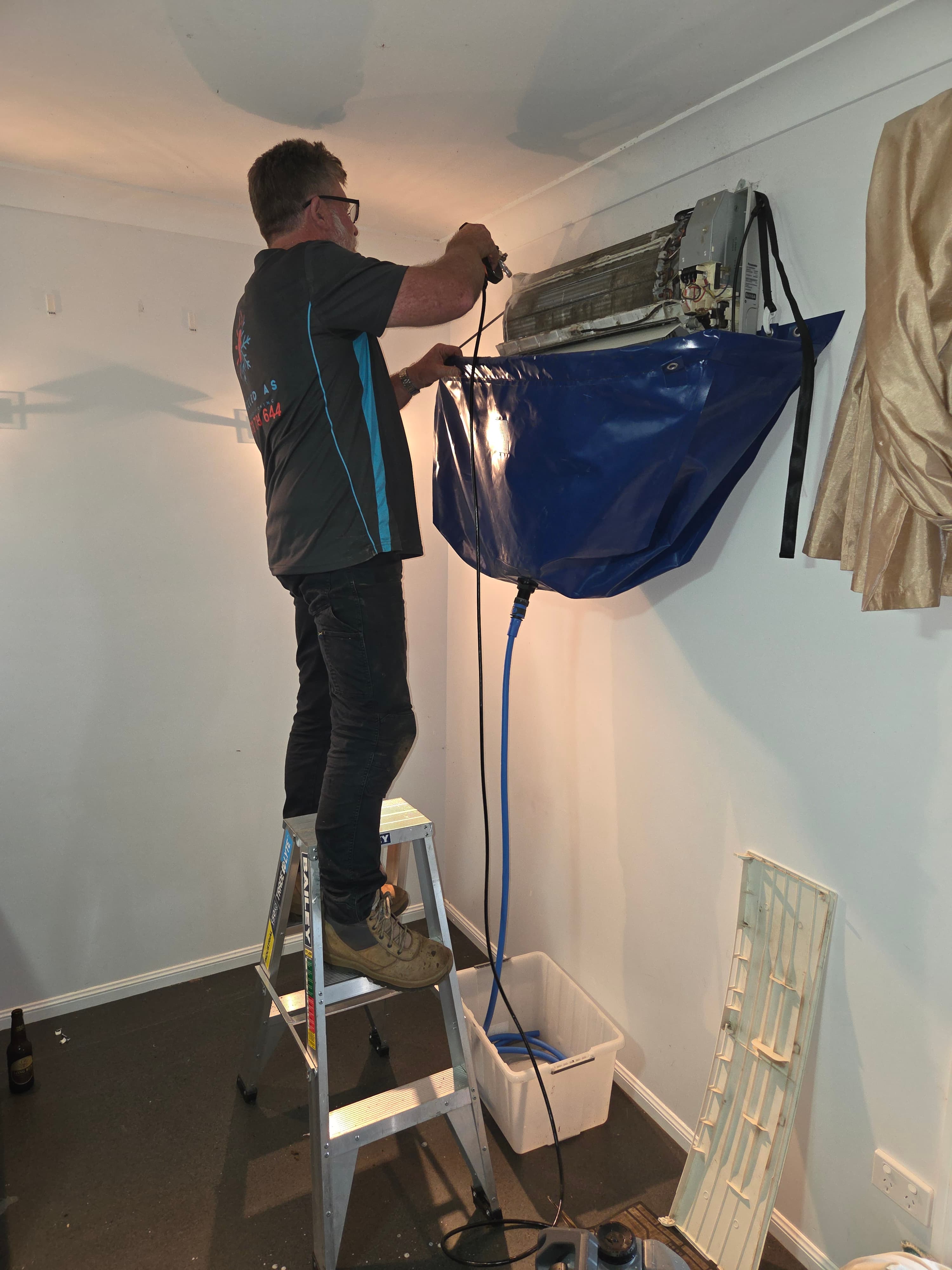 Jon from Chilled As Air Conditioning performing a split system deep clean